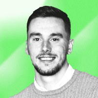 Dan Nation - Man with short dark hair and a beard smiling, on a green background.